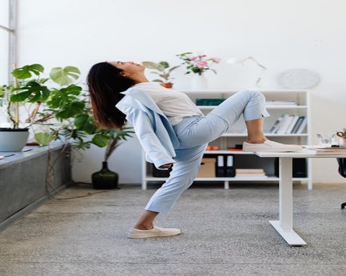 Person standing up and stretching near office desk