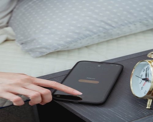 Person turning off mobile phone at night